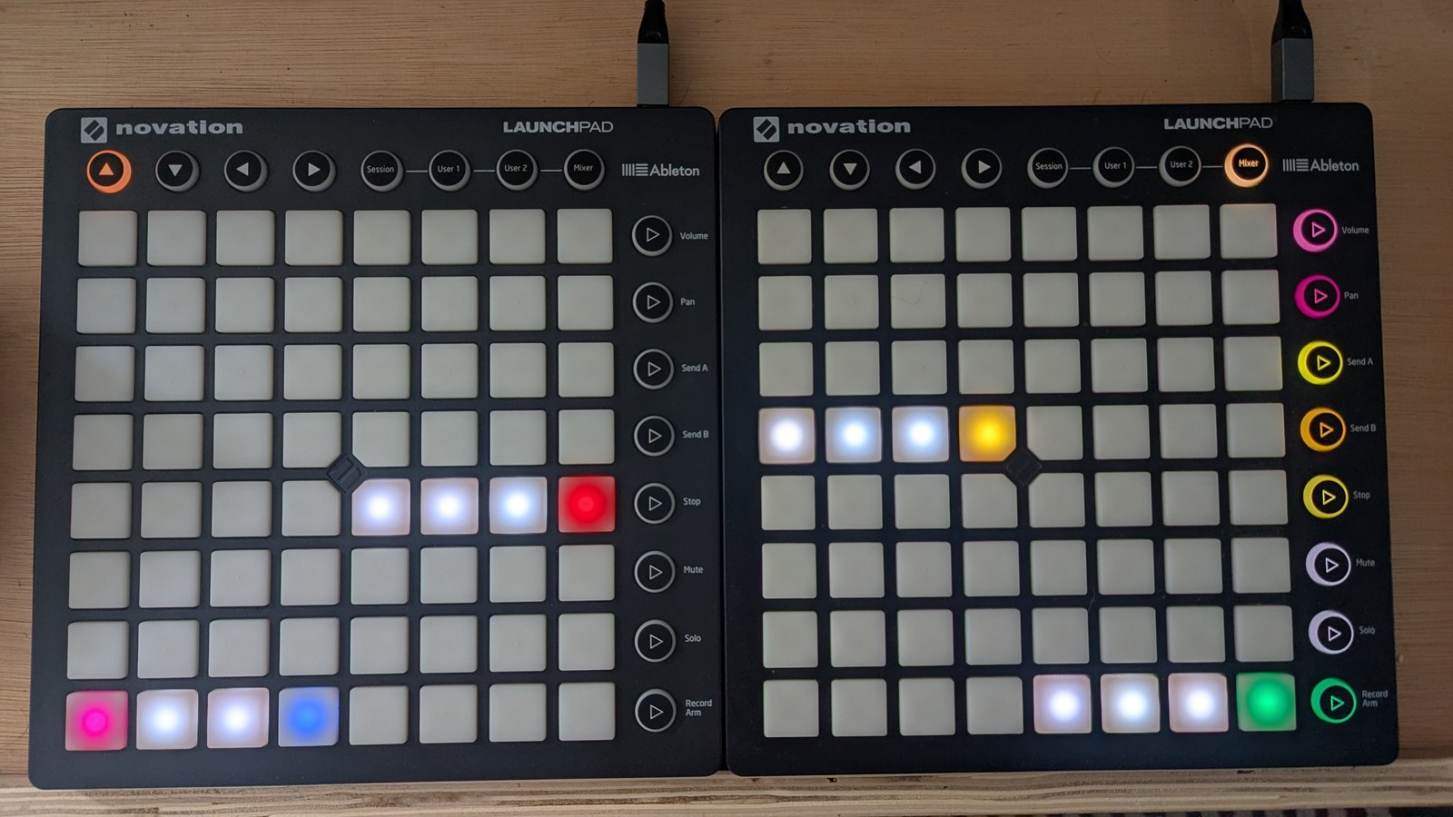 The chord progression grid: sixteen columns in four blocks of four, the first and last blocks on the bottom row, the second block three rows up and the third one row above that, with the last pad of each block a different colour from the three before it, photographed on the hardware