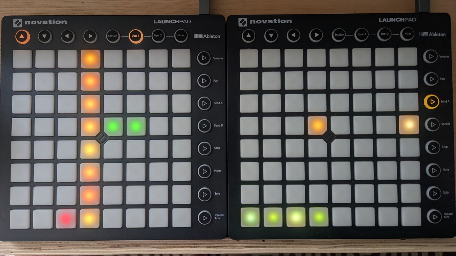 A row-octave grid: a mustard centre column labelled with each row's note, one red pad left of centre on the bottom row labelled C2, and two green pads right of centre on the G3 row labelled G4 and G5; on the LP RHS the bottom row begins +1, +2, +1, +2, while the G3 row contains −2 and −1, photographed on the hardware
